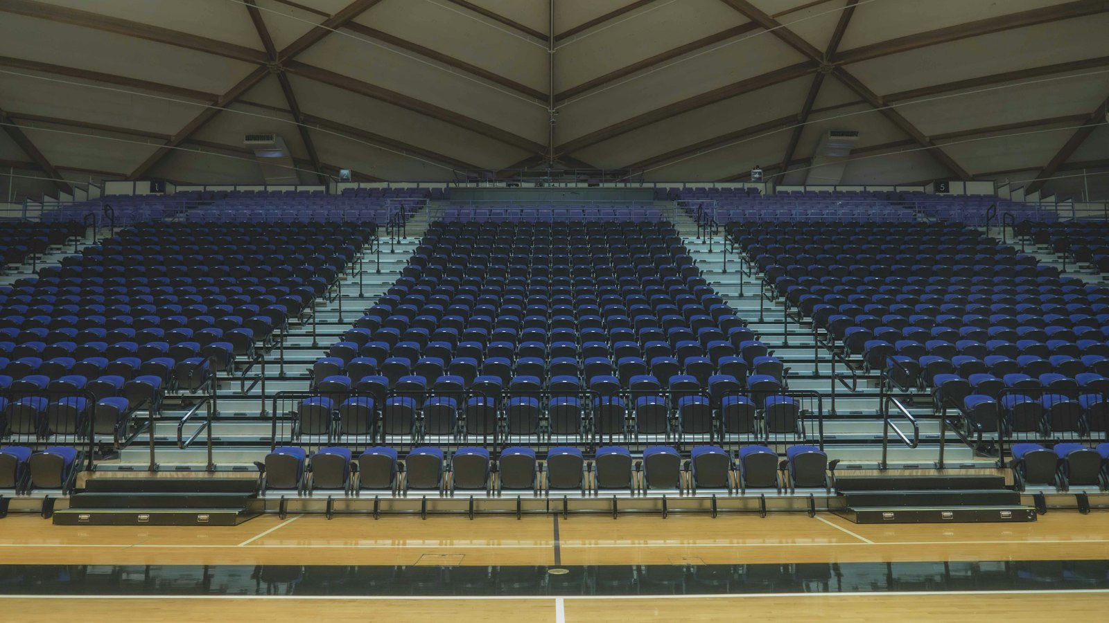 Empty basketball arena with rows of seats