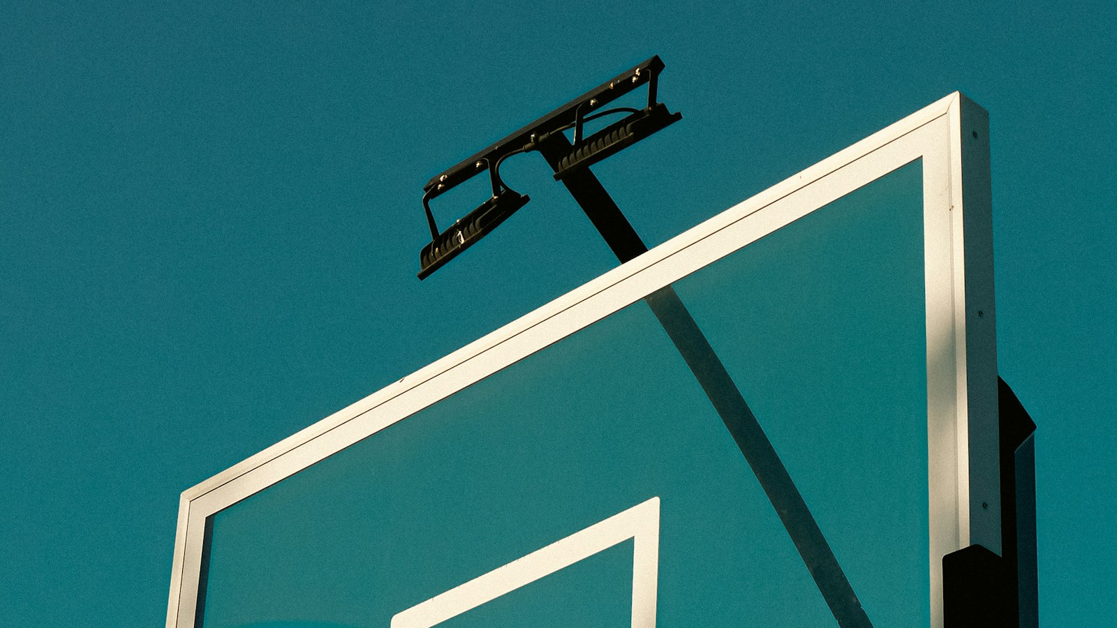 Basketball backboard and net against the sky